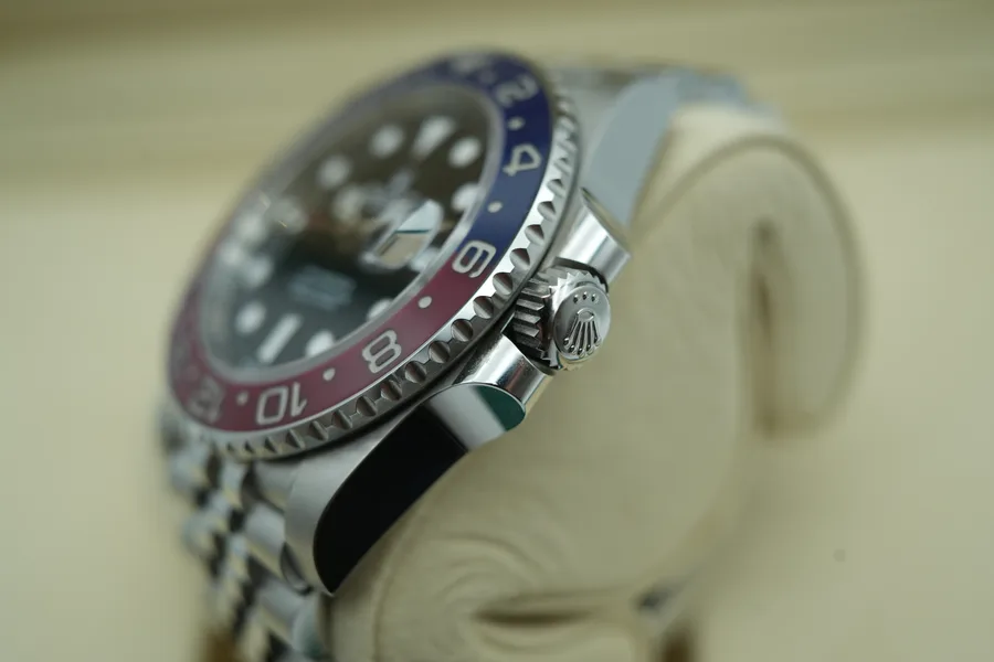 Rolex GMT-Master II photographed straight down on a neutral surface, dial and bezel clearly lit.